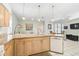 Spacious kitchen island featuring granite countertops and a breakfast bar, seamlessly flowing into the adjacent living area at 10726 Old Grove Cir, Bradenton, FL 34212