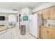 Kitchen area showcasing stainless steel appliances, white refrigerator, and ample counter space, open to the living area at 10726 Old Grove Cir, Bradenton, FL 34212
