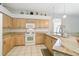 Bright kitchen with granite countertops, tiled floors, pendant lighting and abundant cabinetry for storage at 10726 Old Grove Cir, Bradenton, FL 34212