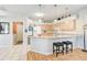 Open concept kitchen featuring wood floors, central island with seating and stainless steel appliances at 10726 Old Grove Cir, Bradenton, FL 34212