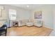 Cozy living room with hardwood floors and natural light, adjacent to the kitchen area at 10726 Old Grove Cir, Bradenton, FL 34212