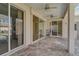 Spacious patio area with ceiling fans and sliding glass doors that seamlessly blend indoor and outdoor living at 10726 Old Grove Cir, Bradenton, FL 34212