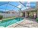 Enjoy this pristine screened pool, complimented by a paved patio and lush backyard views at 10726 Old Grove Cir, Bradenton, FL 34212