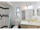 Traditional bathroom featuring a vanity, toilet, and tiled shower with black and white accents at 1208 Francis Ave, Sarasota, FL 34232