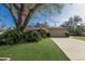Charming single-story home with a well-manicured lawn and mature landscaping at 1208 Francis Ave, Sarasota, FL 34232