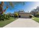 Inviting single-story home with a long driveway leading to a spacious two-car garage at 1208 Francis Ave, Sarasota, FL 34232
