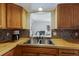 Close up of kitchen sink with window and view to next room at 1208 Francis Ave, Sarasota, FL 34232