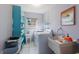 Functional laundry room with washer, dryer, storage shelving, and a utility sink at 1208 Francis Ave, Sarasota, FL 34232