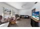 Spacious living room with pool view, featuring a modern television and comfortable seating at 1208 Francis Ave, Sarasota, FL 34232