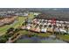 Aerial view of lakeside homes with lush landscaping, golf course, and serene lake views at 1358 Berkshire Ct, Venice, FL 34292