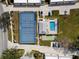 Aerial view of community amenities, including pool, tennis court and shuffleboard near residential buildings at 1358 Berkshire Ct, Venice, FL 34292