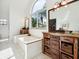 Spacious bathroom with dual vanities, a soaking tub, and a walk-in shower at 1358 Berkshire Ct, Venice, FL 34292