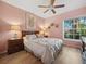Inviting bedroom with a ceiling fan, wood floors, and plenty of natural light at 1358 Berkshire Ct, Venice, FL 34292