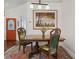 Dining room area showcasing an elegant wooden table set, chairs, and unique artwork at 1358 Berkshire Ct, Venice, FL 34292