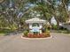 Waterford Berkshire Place entrance sign, with beautiful landscaping and mature trees lining the driveway at 1358 Berkshire Ct, Venice, FL 34292