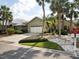 Beautiful home with a two-car garage, tropical landscaping, and a well-maintained lawn at 1358 Berkshire Ct, Venice, FL 34292