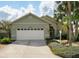 Charming single-story home featuring a two-car garage and manicured landscaping at 1358 Berkshire Ct, Venice, FL 34292