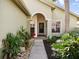 Inviting front entrance with walkway, landscaped garden and glass paneled front door at 1358 Berkshire Ct, Venice, FL 34292