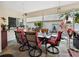 The lanai features outdoor dining under overhead lanterns, with views of the backyard and palm trees at 1358 Berkshire Ct, Venice, FL 34292