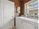 Neat laundry room features a window for natural light and a washer and dryer set at 1358 Berkshire Ct, Venice, FL 34292