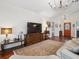 Comfortable living room with hardwood floors, large TV, and stylish decor at 1358 Berkshire Ct, Venice, FL 34292