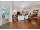 Bright living room with wood floors, chandelier, and open floor plan at 1358 Berkshire Ct, Venice, FL 34292