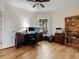 Bright office space with wood floors, ceiling fan, large desk, and ample storage at 1358 Berkshire Ct, Venice, FL 34292