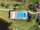 Aerial view of community pool and patio area, complete with lounge chairs and well-maintained landscaping at 1358 Berkshire Ct, Venice, FL 34292