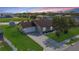 An aerial view of a cozy home featuring a manicured lawn, mature trees, and a lengthy driveway at 1406 14Th Street W Ct, Palmetto, FL 34221