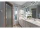Bright bathroom featuring double sinks, a large mirror, decorative lighting, and a glass shower door at 1406 14Th Street W Ct, Palmetto, FL 34221