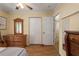 This bedroom features hardwood floors, a closet, and a dresser with a mirror at 1406 14Th Street W Ct, Palmetto, FL 34221