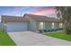 Charming single-story home with a well-manicured lawn, stone accents, and a two-car garage at 1406 14Th Street W Ct, Palmetto, FL 34221