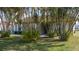 Single-story home with palm trees on well-maintained lawn at 1406 14Th Street W Ct, Palmetto, FL 34221