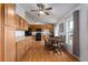 Bright kitchen area featuring wood cabinets, modern black appliances, and an adjacent dining table set at 1406 14Th Street W Ct, Palmetto, FL 34221