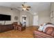 Inviting living room with warm wood floors, ceiling fan, and a cozy seating area with a view to the bedroom at 1406 14Th Street W Ct, Palmetto, FL 34221
