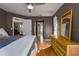 A spacious primary bedroom with wood floors, ample natural light, wicker dresser, and access to a private bath at 1406 14Th Street W Ct, Palmetto, FL 34221