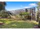 Manicured backyard featuring a screened porch that combines indoor-outdoor living at 1529 Oak Way, Sarasota, FL 34232