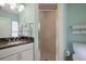 Bathroom featuring a vanity with a dark countertop and shower with clear glass doors at 1529 Oak Way, Sarasota, FL 34232