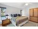 Cozy bedroom with a large window, ceiling fan, and wood furnishings at 1529 Oak Way, Sarasota, FL 34232