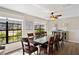 Bright dining room with large windows, a ceiling fan, and a spacious table with seating at 1529 Oak Way, Sarasota, FL 34232