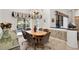 Dining room with stylish decor, chandelier, and glass doors leading to outdoor pool at 1529 Oak Way, Sarasota, FL 34232
