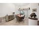 Dining room with chandelier, stylish decor, and sunlit windows at 1529 Oak Way, Sarasota, FL 34232