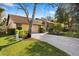Charming home with attached garage, spacious driveway, and well-maintained landscaping at 1529 Oak Way, Sarasota, FL 34232