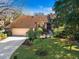 Beautiful home with attached garage, lush landscaping, and well-manicured lawn at 1529 Oak Way, Sarasota, FL 34232