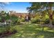 Charming single-story home with lush front yard landscaping, mature trees, and inviting entryway at 1529 Oak Way, Sarasota, FL 34232
