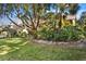 Beautiful yard with mature trees and professional landscaping at 1529 Oak Way, Sarasota, FL 34232
