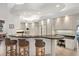 Modern kitchen with a large curved island, modern appliances, and custom lighting at 1529 Oak Way, Sarasota, FL 34232