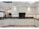A well-designed kitchen features granite countertops and sleek white cabinetry at 1529 Oak Way, Sarasota, FL 34232