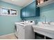 Laundry room featuring modern appliances, a sink, and ample storage space at 1529 Oak Way, Sarasota, FL 34232
