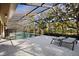 A screened-in pool area offers a relaxing outdoor retreat with lounge chairs at 1529 Oak Way, Sarasota, FL 34232